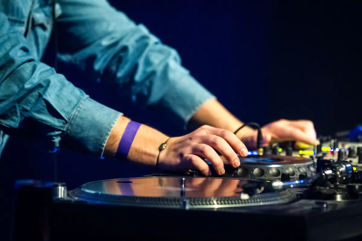 Hands mixing on turntables