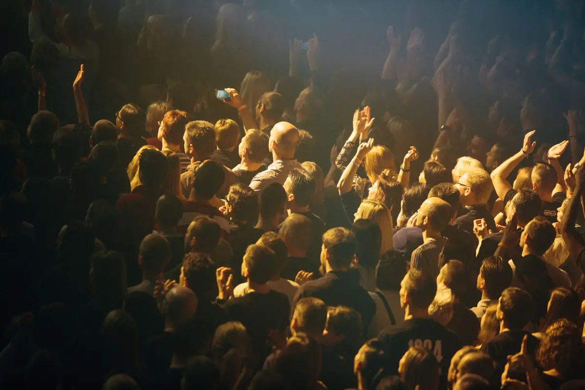 A crowd enjoying live music under warm lights